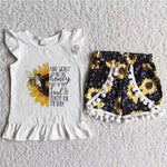White shirt with half sunflowers and bee black shorts with sunflowers