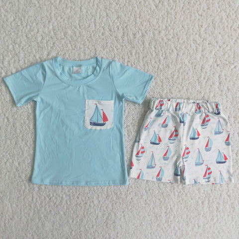 Sky blue shirt with a pocket white shorts with ships and sea mew