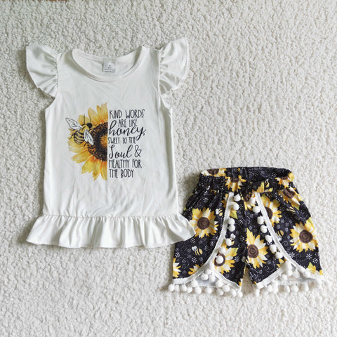 White shirt with half sunflowers and bee black shorts with sunflowers